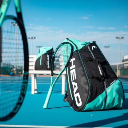 Tennisbag in black and mint with HEAD in white 12 racquet bag on court with HEAD BOOM matching the bag