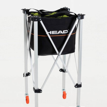 Trolley with black bag and black mesh top for tennis balls. Orange line on the side of the bag with HEAD in white writing above.