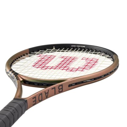 Side view from grip of green/brown iridescent tennis racquet with black top and black grip. Wilson Blade 100 v8.0.