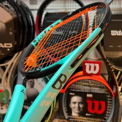 Mint and black tennis racquet from HEAD. Black and orange strings strung like Ivan Lendl's box string pattern. Mint grip. HEAD Boom MP.