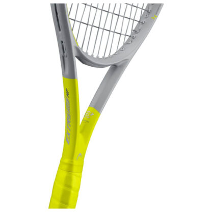 The throat of grey and yellow tennis racquet from HEAD. Grey strings with black HEAD logo and yellow grip. HEAD in yellow writing on the inside of the beam. Extreme in yellow written on the beam from the throat to the middle of the racquet head. HEAD Extreme MP Graphene 360+.