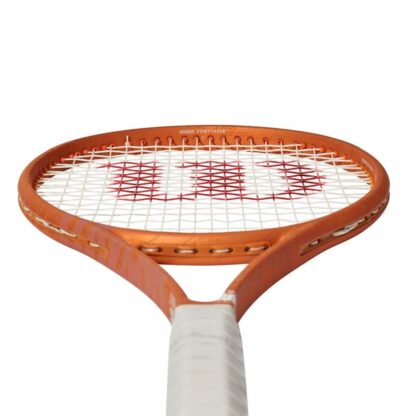 Throat view of orange tennis racquet with grey grip and white strings with red "W" for Wilson. White Roland Garros logo at the bottom of the throat. Wilson Blade 98 18x20 v8.0 Roland Garros Edition.