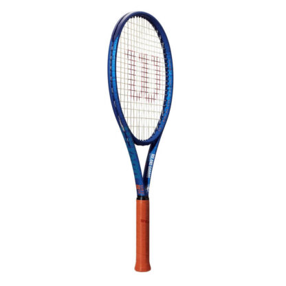 Side view of blue tennis racquet with clay grip and white strings with red "W" for Wilson. White Roland Garros logo at the bottom of the throat. Wilson Clash 100 v2.0 Roland Garros Edition. Wilson in blue writing on the side of the beam.