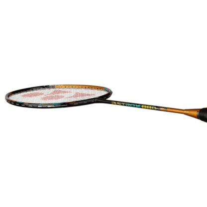 Side view of black and gold badminton racquet with turquoise details from Yonex. Astrox 88 D Play in gold, turquoise and white writing on the side of the shaft. White strings with red Yonex logo and black grip. Yonex Astrox 88 D Play in Camel Gold.