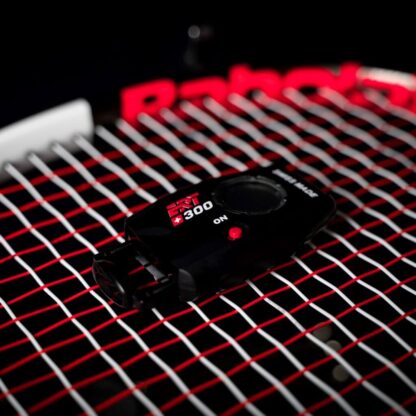 Dynamic String tension measurement device on red and white tennis stringbed. ERT300 version 2.