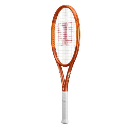 Side view of orange tennis racquet with white grip. White Roland Garros logo at the bottom of the throat. Team 102 in gold writing at the side of the throat. Wilson Roland Garros Team 102