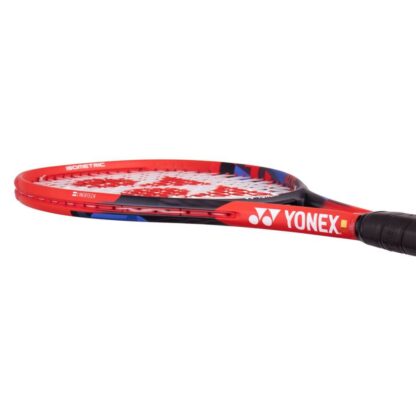 Lying view of red, black and blue tennis racquet from Yonex. White strings with red Yonex logo and black grip. Yonex in silver writing on the side with silver Yonex logo. Yonex Vcore 25 2023 model.