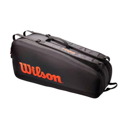 Black tennis bag with red/orange details. Wilson in red/orange writing on the side.
