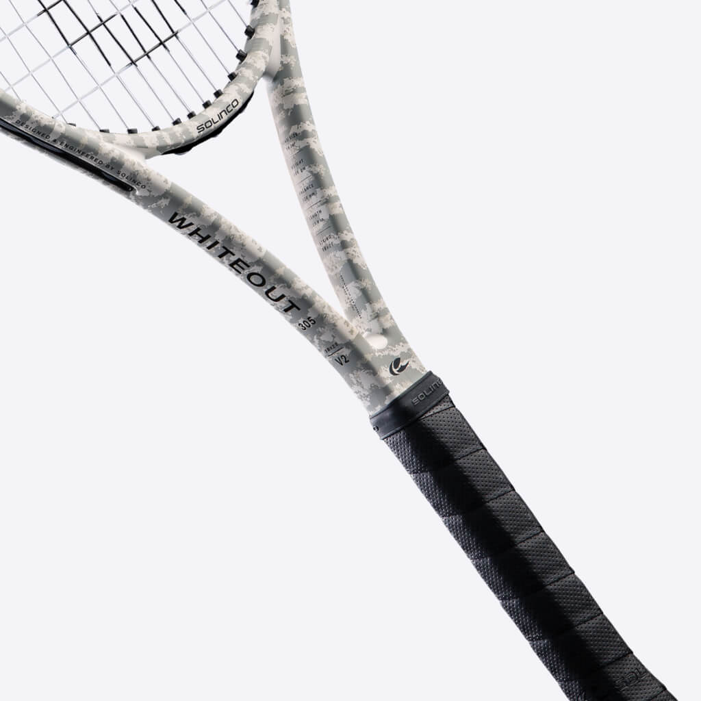 Closeup of throat of white and grey camo tennis racquet from Solinco. Black grip. WhiteOut in black writing on the side with black Solinco logo. Solinco WhiteOut 98 305 18x20 V2 Camo model.